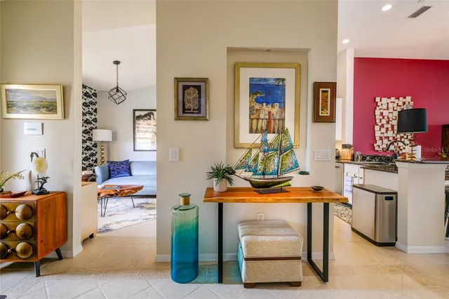 a kitchen with granite countertop a refrigerator and a stove top oven