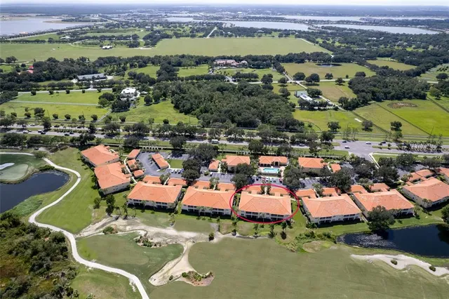 an aerial view of a houses with a lake