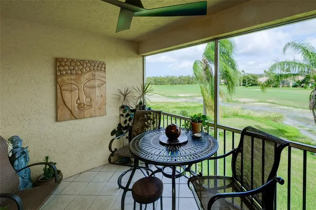 a view of swimming pool that has lawn chairs with plants and trees
