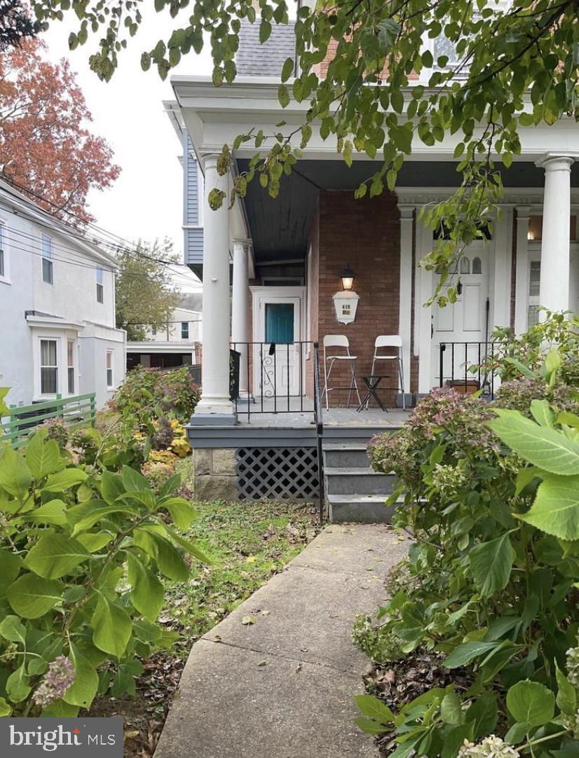 a front view of a house with a lots of flower garden