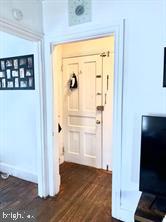 419 Green Lane, Unit 3 Philadelphia, PA 19128 - Photo 19 of 32 a view of a hallway with wooden floor and a flat screen tv