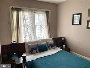 419 Green Lane, Unit 3 Philadelphia, PA 19128 - Photo 26 of 32 a living room with a couch and a window