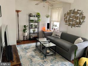 419 Green Lane, Unit 3 Philadelphia, PA 19128 - Photo 29 of 32 a living room with furniture a rug and a flat screen tv