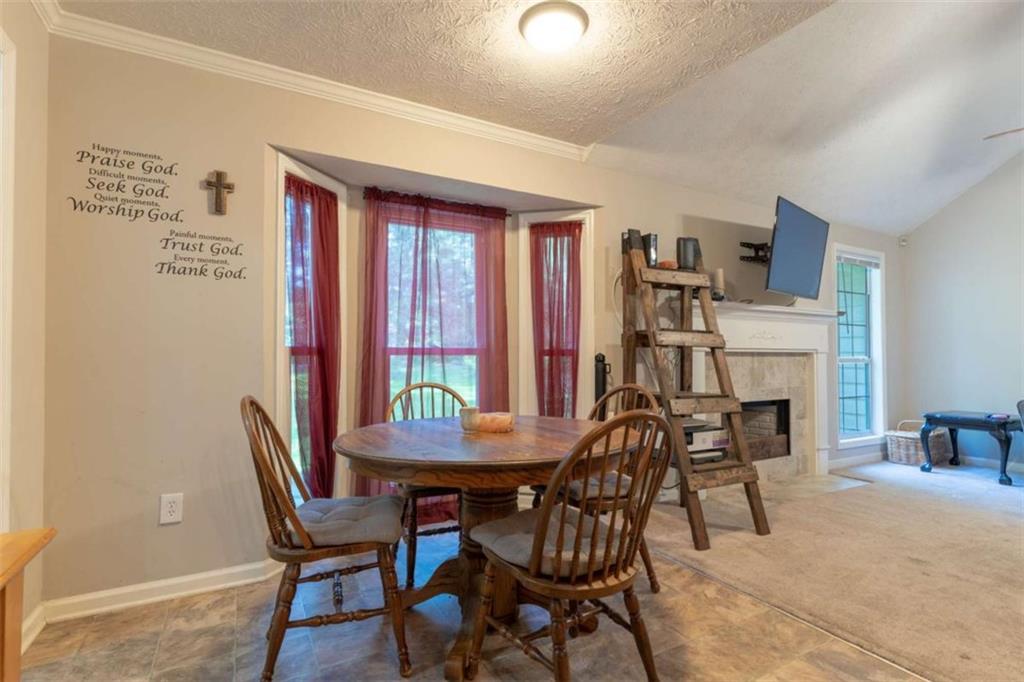 115 Woodland Ridge Circle Covington, GA 30016 - Photo 13 of 30 a view of a dining room with furniture window and outside view
