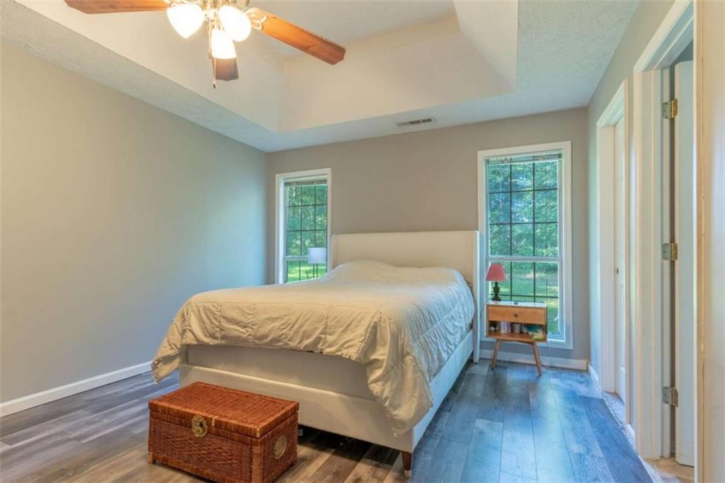 115 Woodland Ridge Circle Covington, GA 30016 - Photo 17 of 30 a bedroom with a bed wooden floor and window
