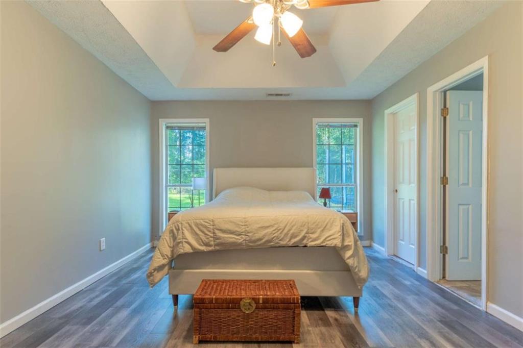115 Woodland Ridge Circle Covington, GA 30016 - Photo 18 of 30 a bedroom with a bed and wooden floor