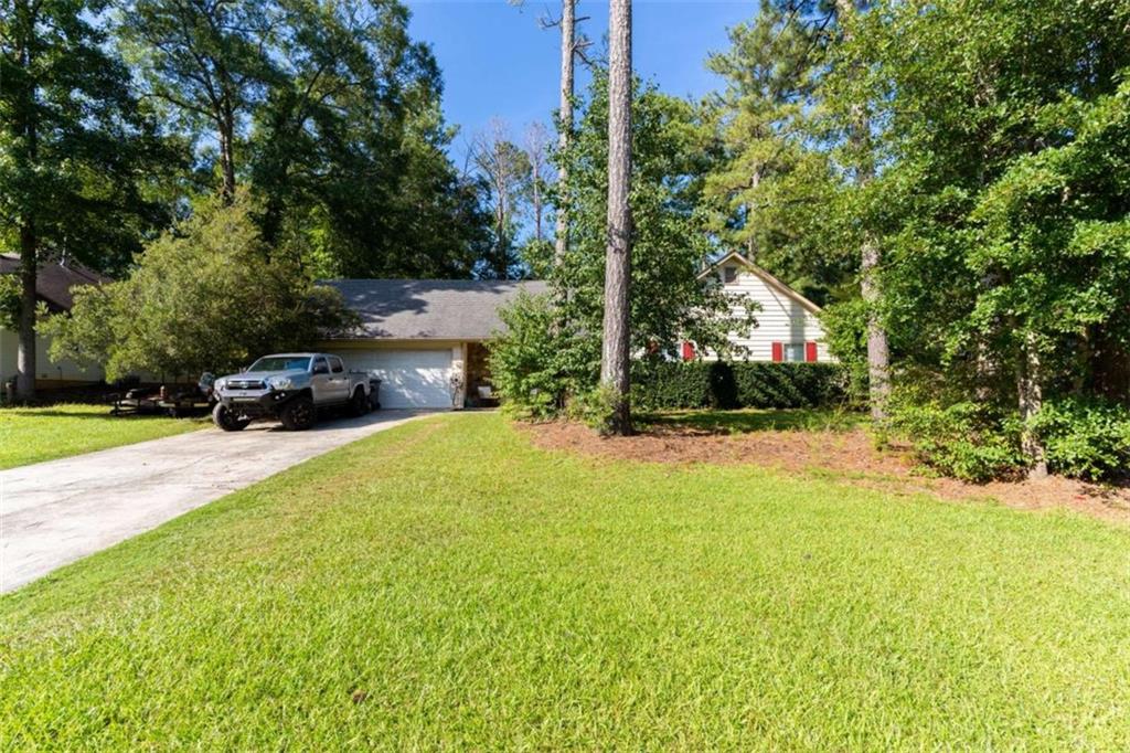 115 Woodland Ridge Circle Covington, GA 30016 - Photo 2 of 30 a view of a yard with potted plants and large trees