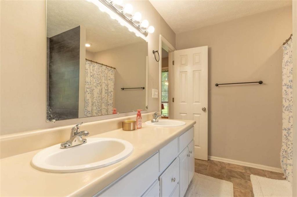 115 Woodland Ridge Circle Covington, GA 30016 - Photo 21 of 30 a bathroom with a sink and a mirror