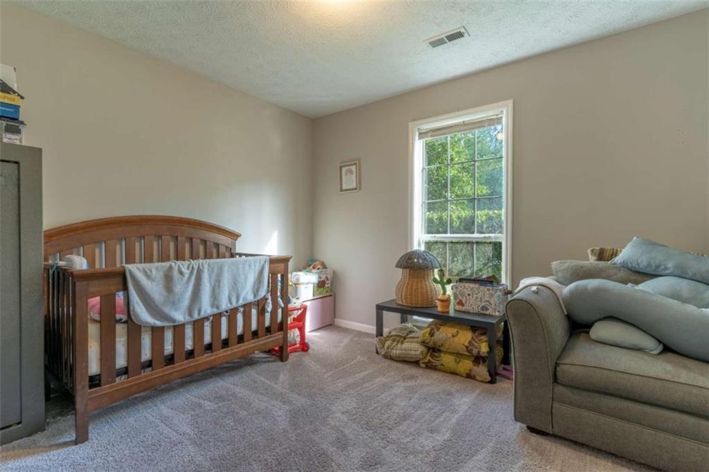115 Woodland Ridge Circle Covington, GA 30016 - Photo 23 of 30 a bedroom with furniture and a window