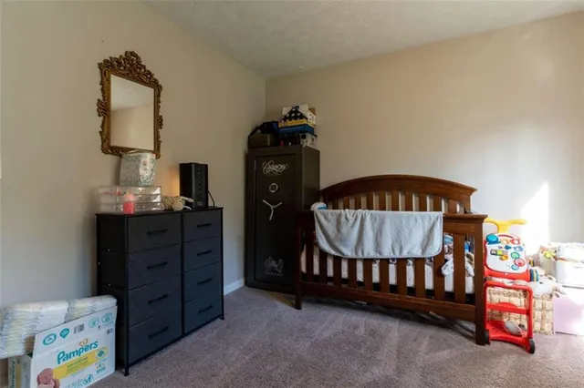 a bedroom with a bed and a baby crib