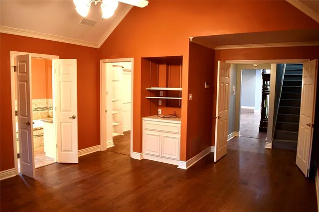 a view of a hallway with wooden floor and closet
