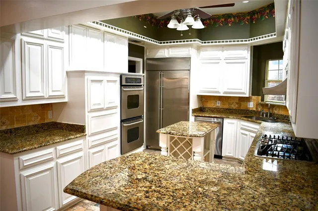 a kitchen with a refrigerator and a stove