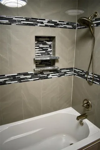 a bathroom with a shower and a sink