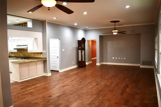a view of a kitchen with a sink and a refrigerator