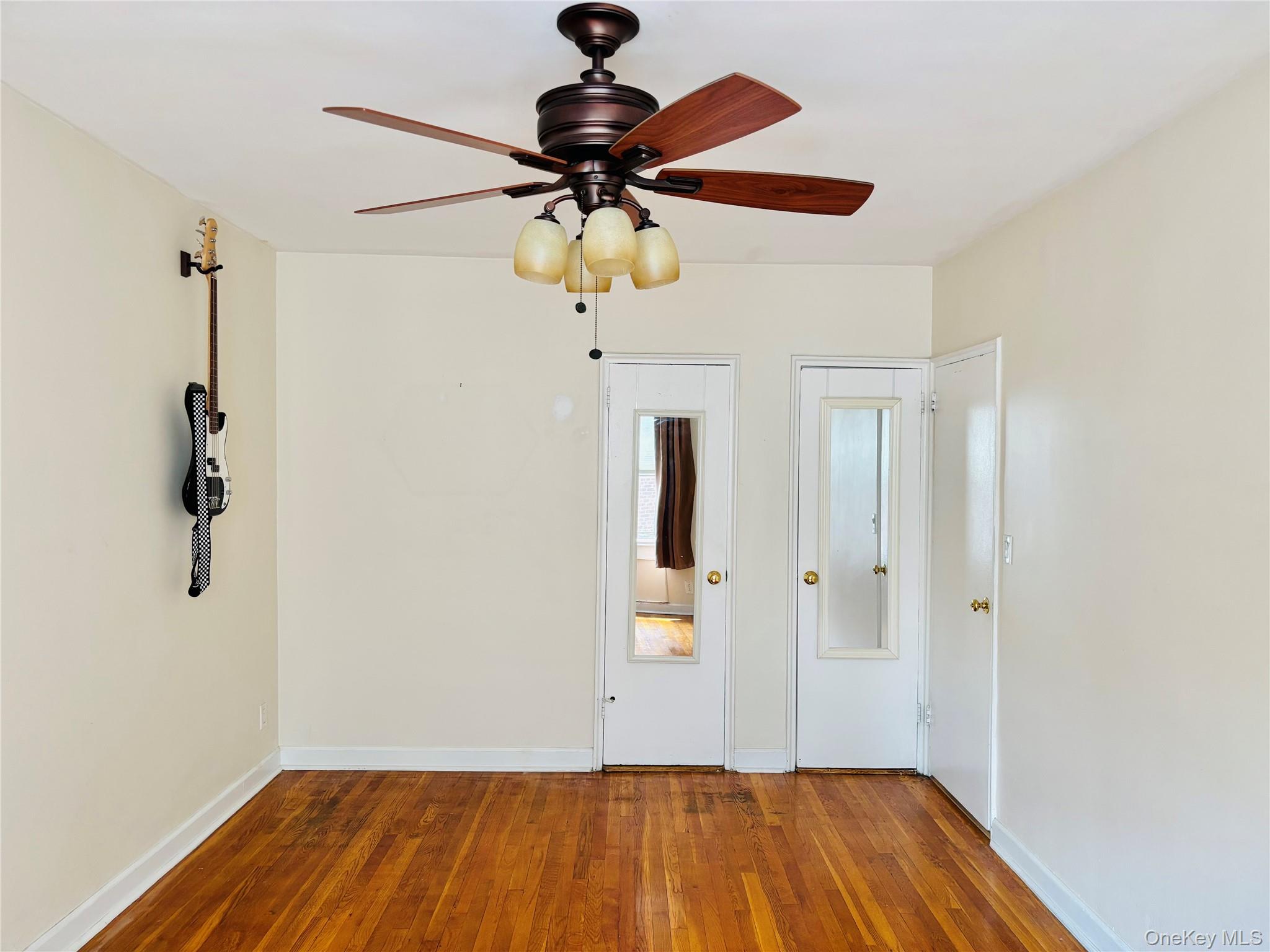 804 Bronx River Road, Unit 4G Bronxville, NY 10708 - Photo 6 of 11 a view of room with a ceiling fan and wooden floor