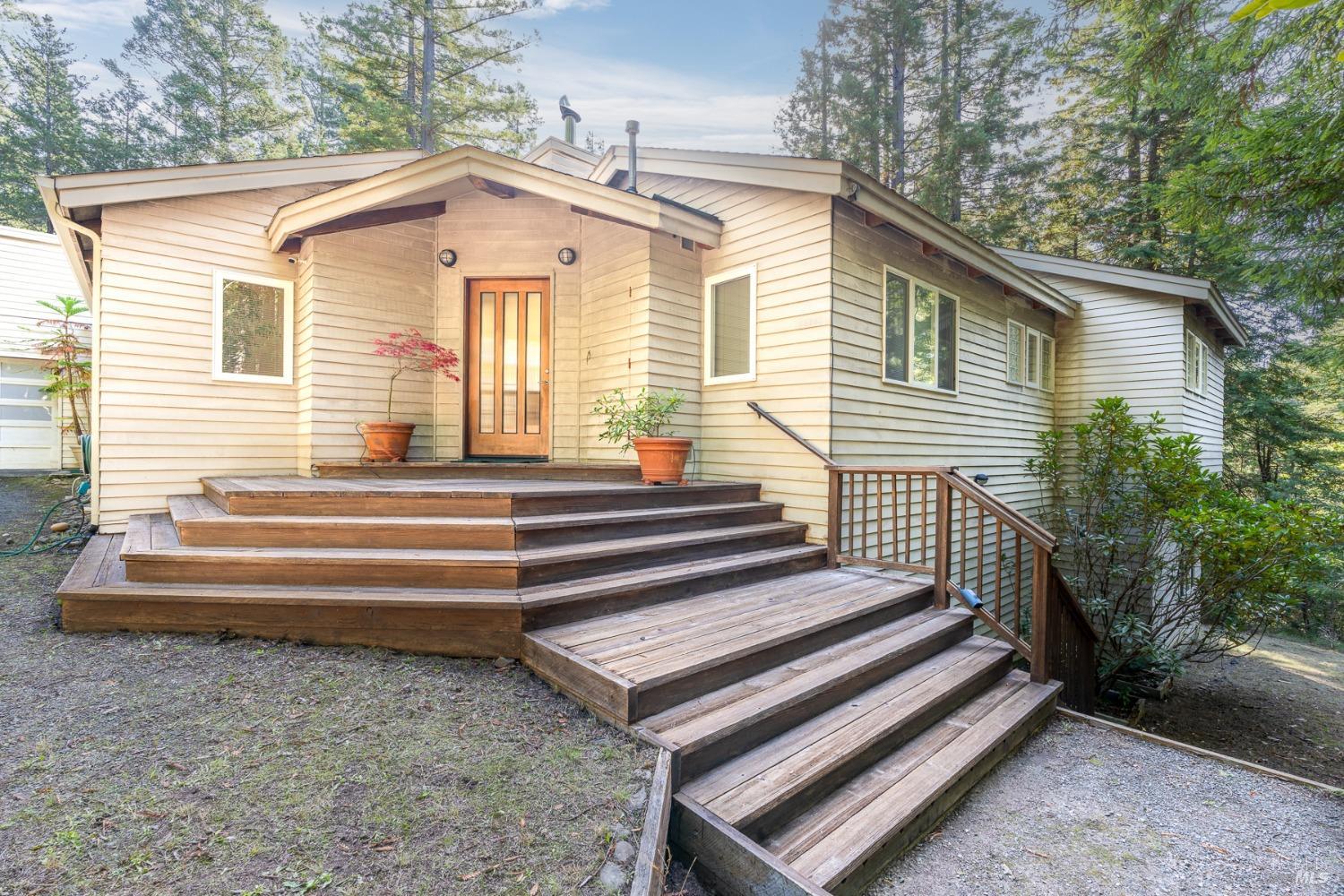 a front view of a house with a garden