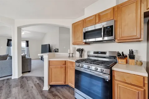a kitchen with stainless steel appliances a stove microwave and cabinets