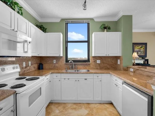 a kitchen with a sink stove and cabinets
