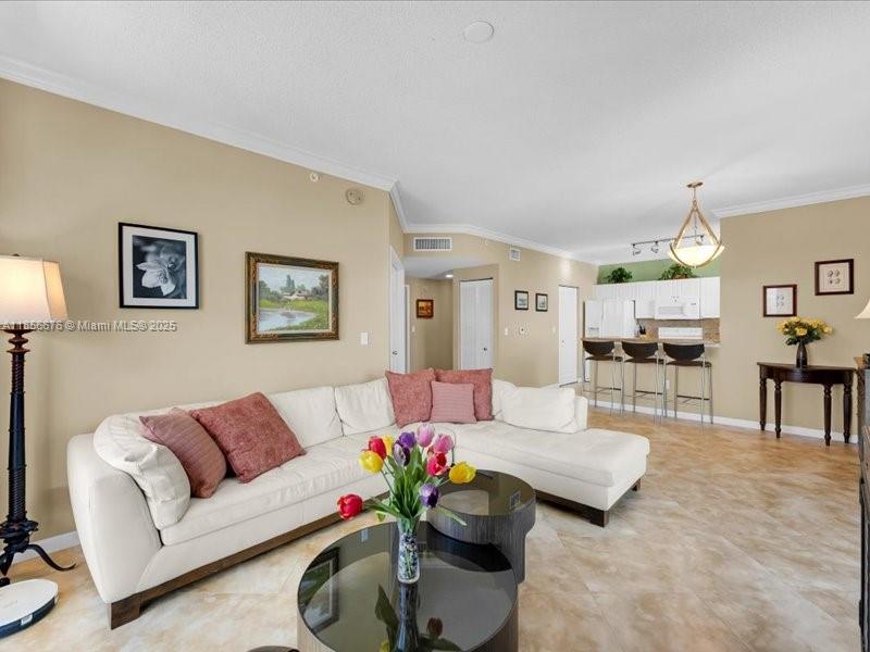 651 Okeechobee Boulevard, Unit 1002 West Palm Beach, FL 33401 - Photo 8 of 22 a living room with furniture and a potted plant