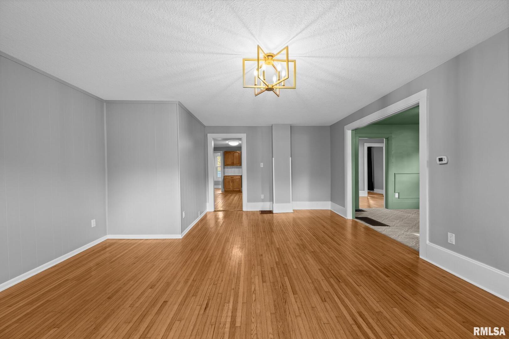 118 South 1st Street Long Grove, IA 52756 - Photo 11 of 41 a view of empty room with wooden floor and fan