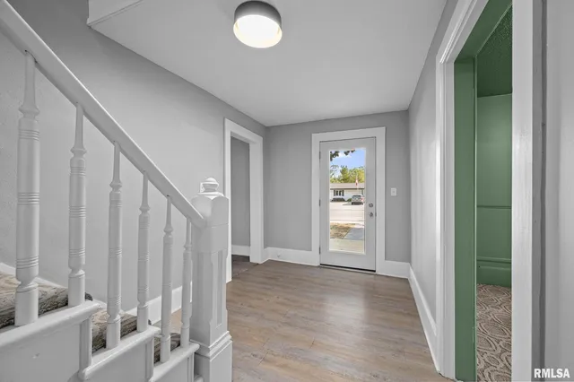 a view of an entryway with wooden floor