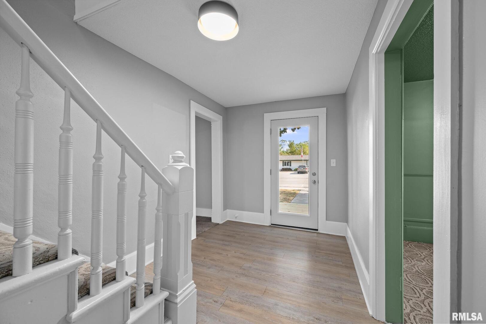 118 South 1st Street Long Grove, IA 52756 - Photo 15 of 41 a view of an entryway with wooden floor