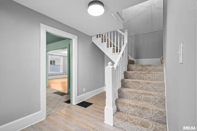 a view of entryway and hall with wooden floor