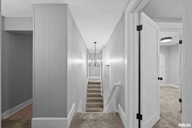 a view of a hallway with hallway and stairs