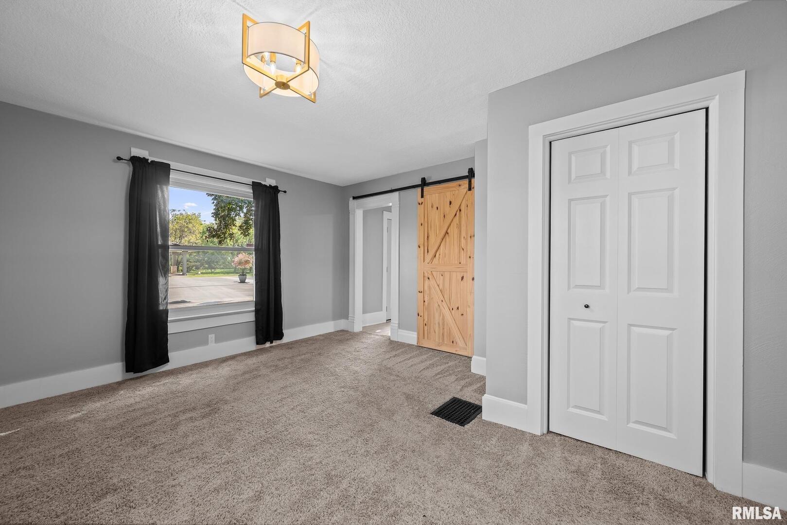 118 South 1st Street Long Grove, IA 52756 - Photo 19 of 41 an empty room with windows and closet