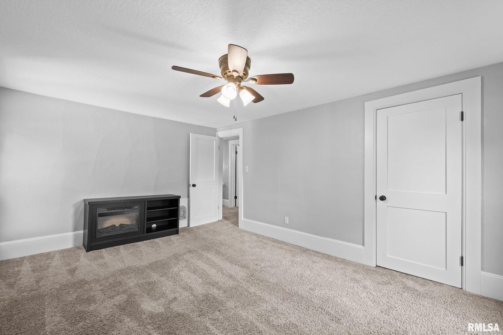 118 South 1st Street Long Grove, IA 52756 - Photo 22 of 41 an empty room with a ceiling fan and a window