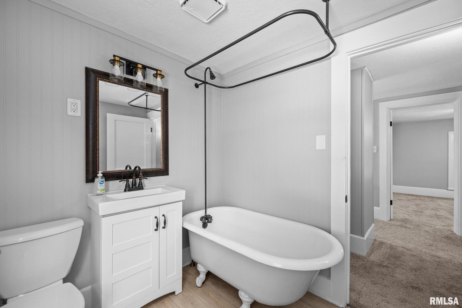 118 South 1st Street Long Grove, IA 52756 - Photo 23 of 41 a bathroom with a toilet sink and mirror