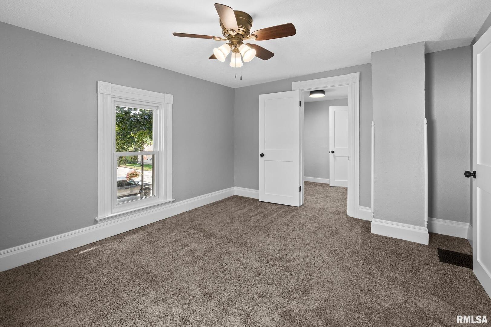 118 South 1st Street Long Grove, IA 52756 - Photo 28 of 41 a view of a livingroom with a ceiling fan and window