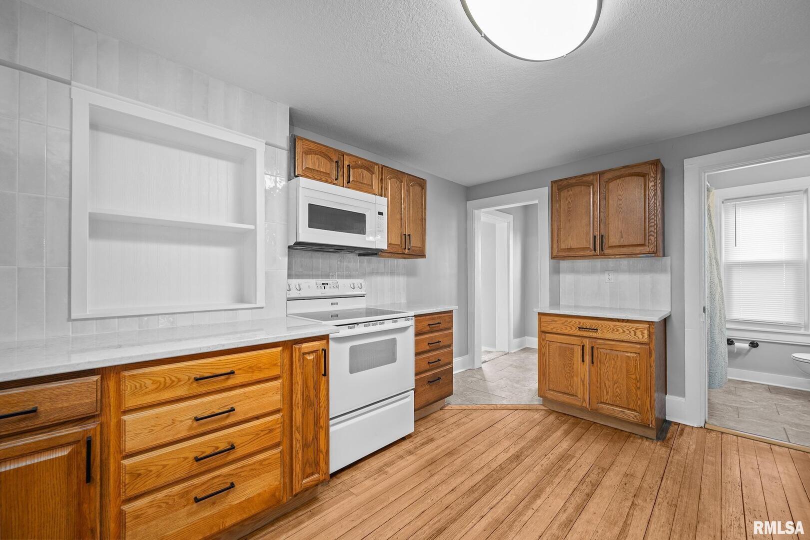 118 South 1st Street Long Grove, IA 52756 - Photo 5 of 41 a kitchen with stainless steel appliances granite countertop a stove and cabinets