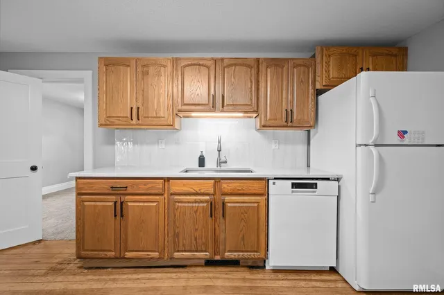 a white refrigerator freezer sitting inside of a kitchen