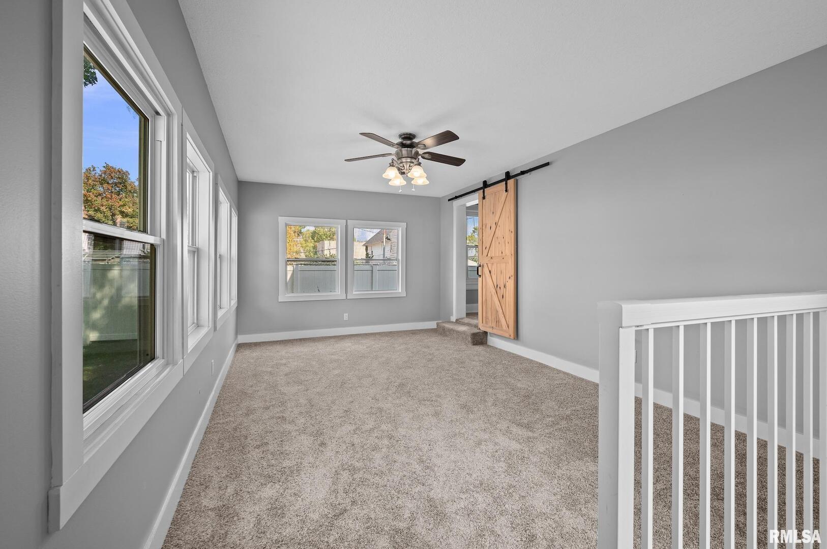 118 South 1st Street Long Grove, IA 52756 - Photo 9 of 41 wooden floor in an empty room with a window