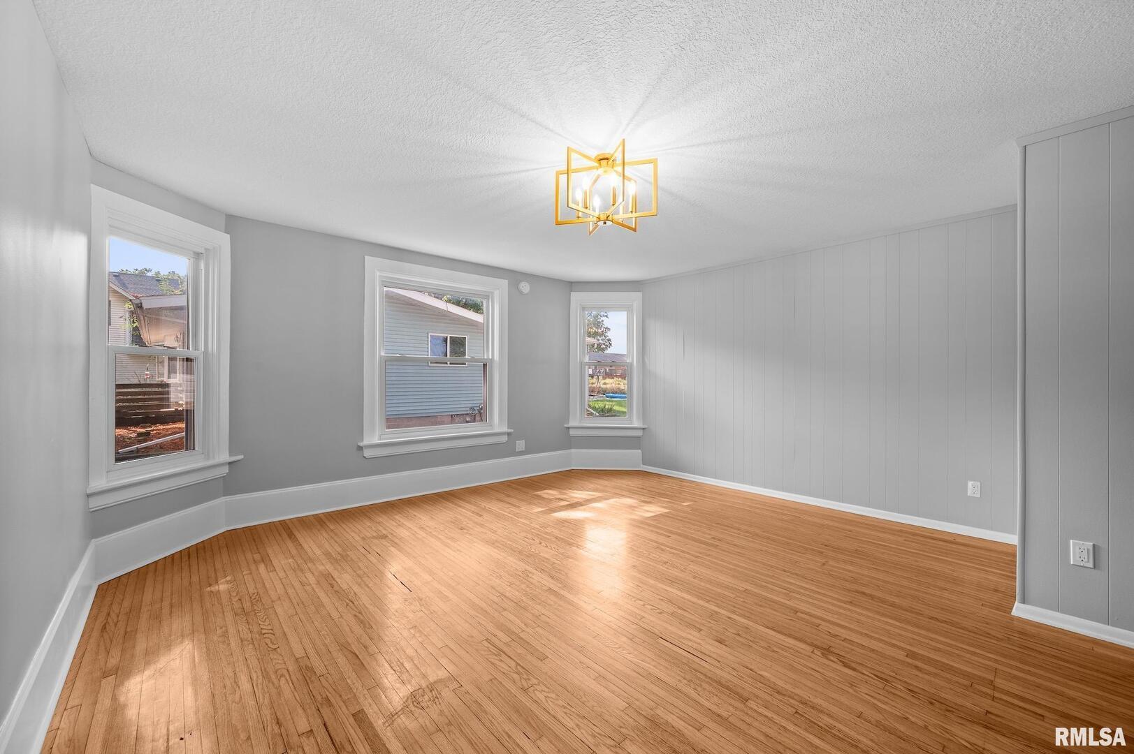118 South 1st Street Long Grove, IA 52756 - Photo 10 of 41 a view of an empty room with wooden floor and a window