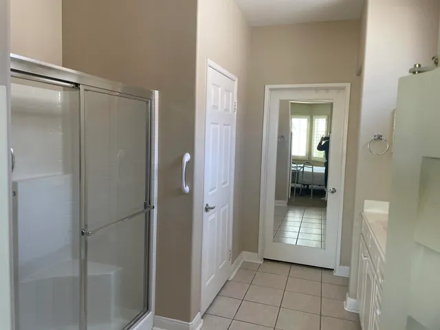 a view of a bathroom with a glass door shower
