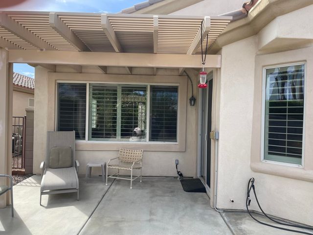 a view of a house with outdoor seating space