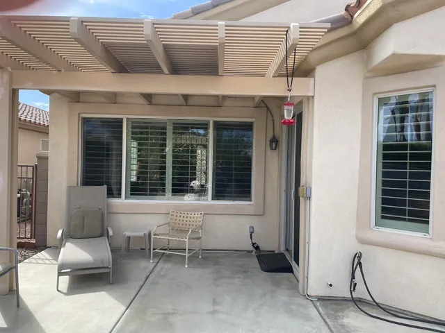 a view of a house with outdoor seating space