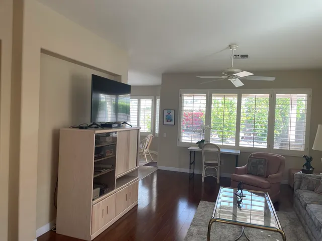 a view of a dining room with furniture window and wooden floor