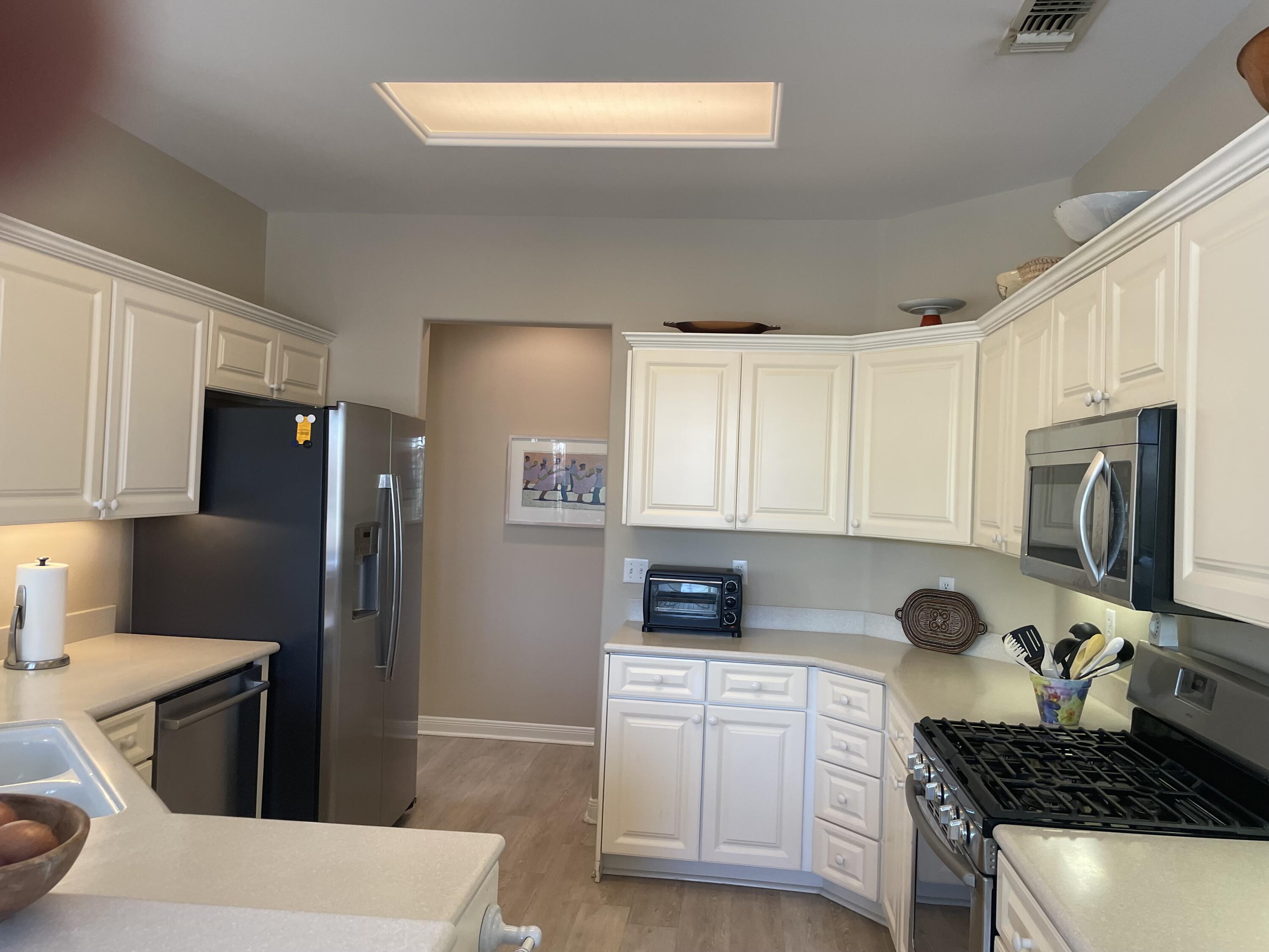 78212 Vinewood Drive Palm Desert, CA 92211 - Photo 7 of 15 a kitchen with a refrigerator and a stove top oven
