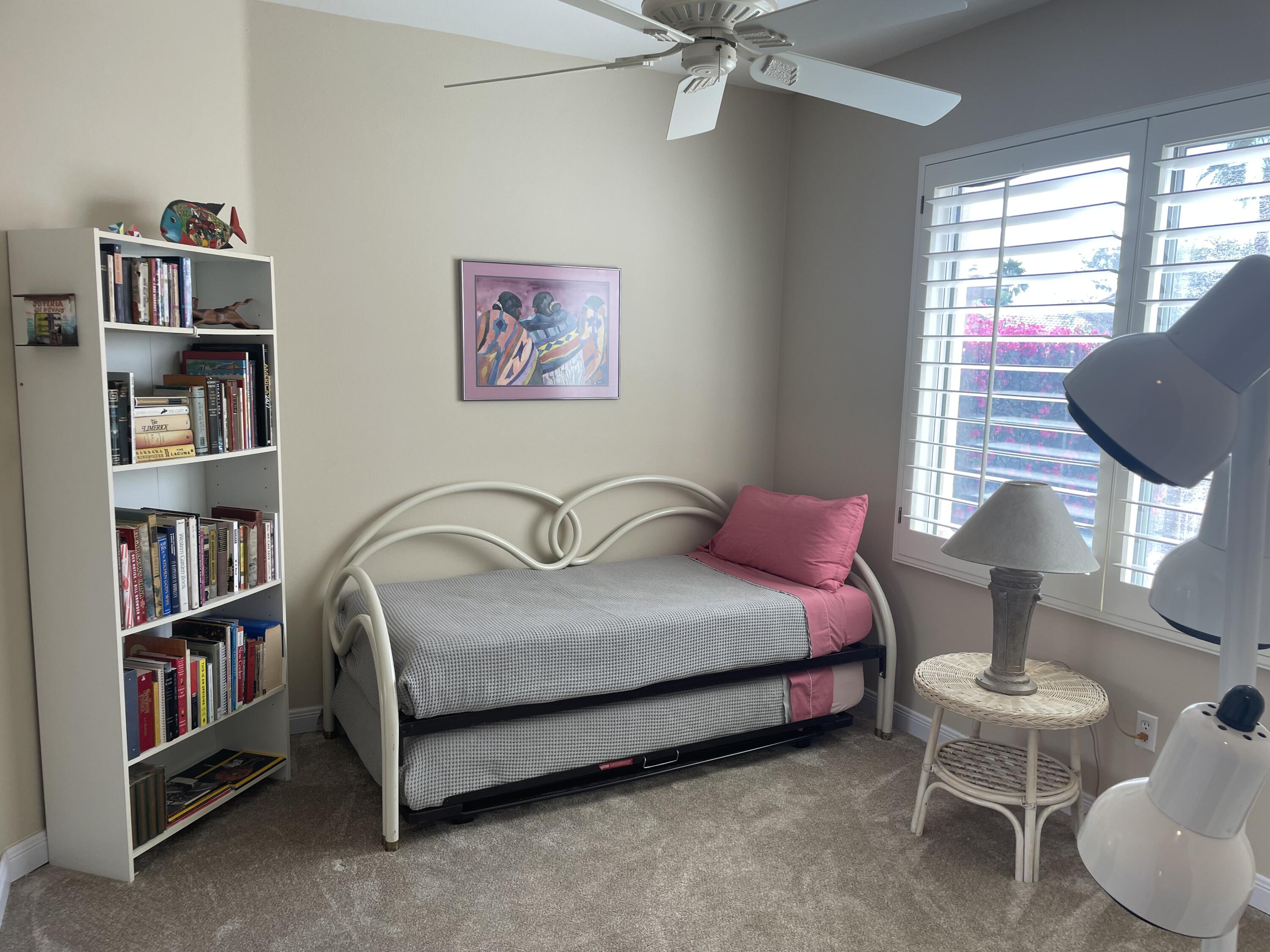 78212 Vinewood Drive Palm Desert, CA 92211 - Photo 8 of 15 a spacious bedroom with a bed and a book shelf