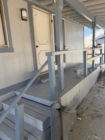 a view of a kitchen with wooden floor and window