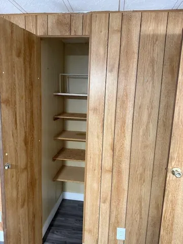 a white toilet sitting next to a bathroom sink and vanity