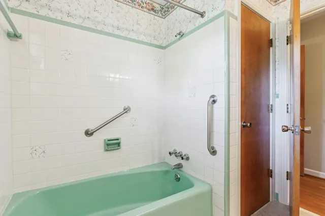 a bathroom with a bathtub and a shower