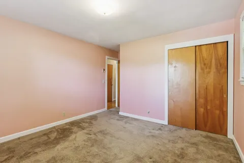 an empty room with closet area