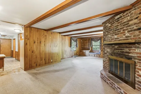 a view of an empty room with a fireplace