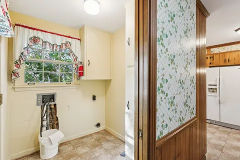 a view of a hallway with wooden floor and a window