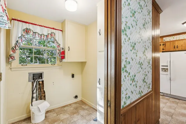 a view of a hallway with wooden floor and a window