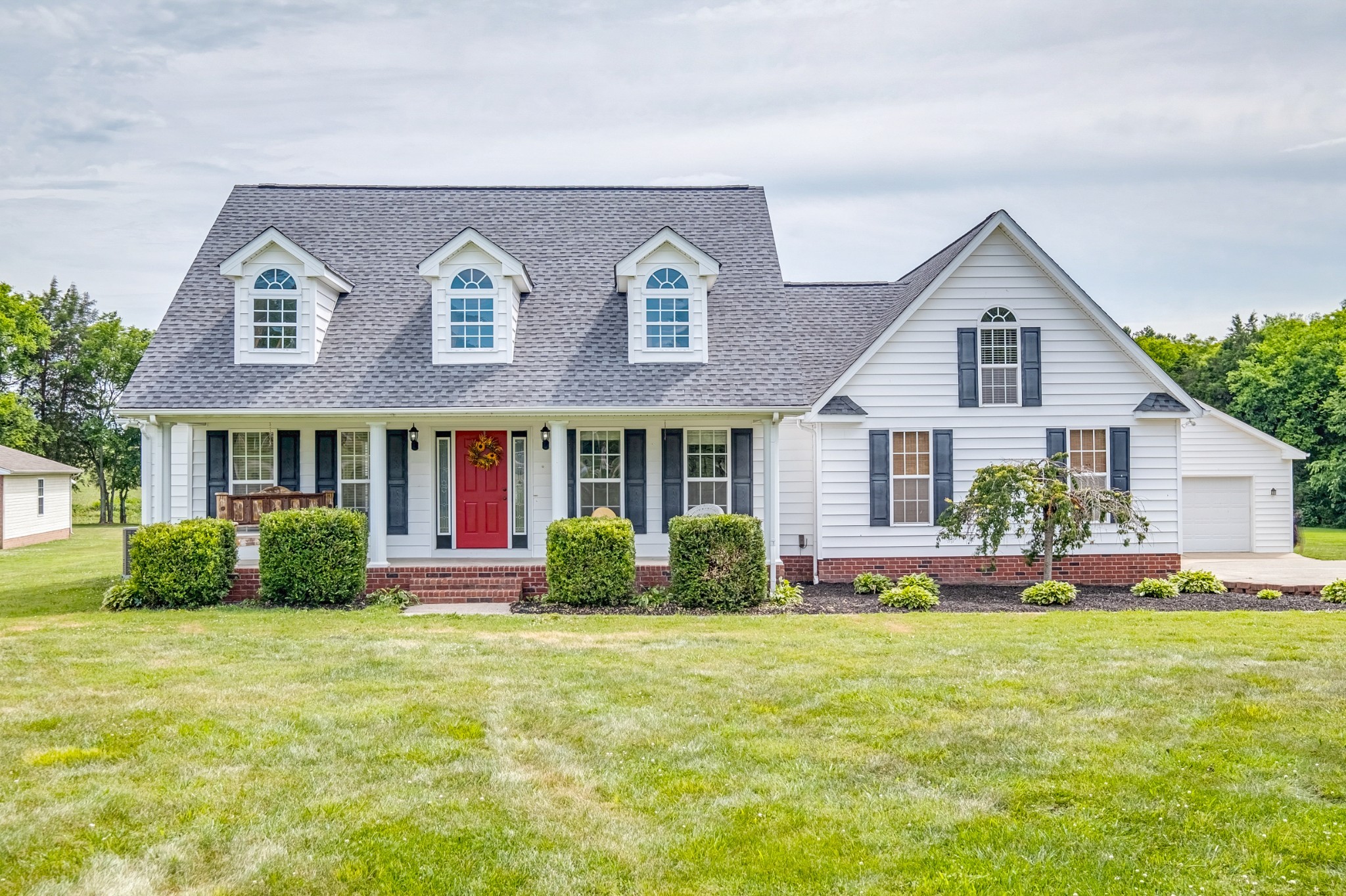 a front view of a house with a yard